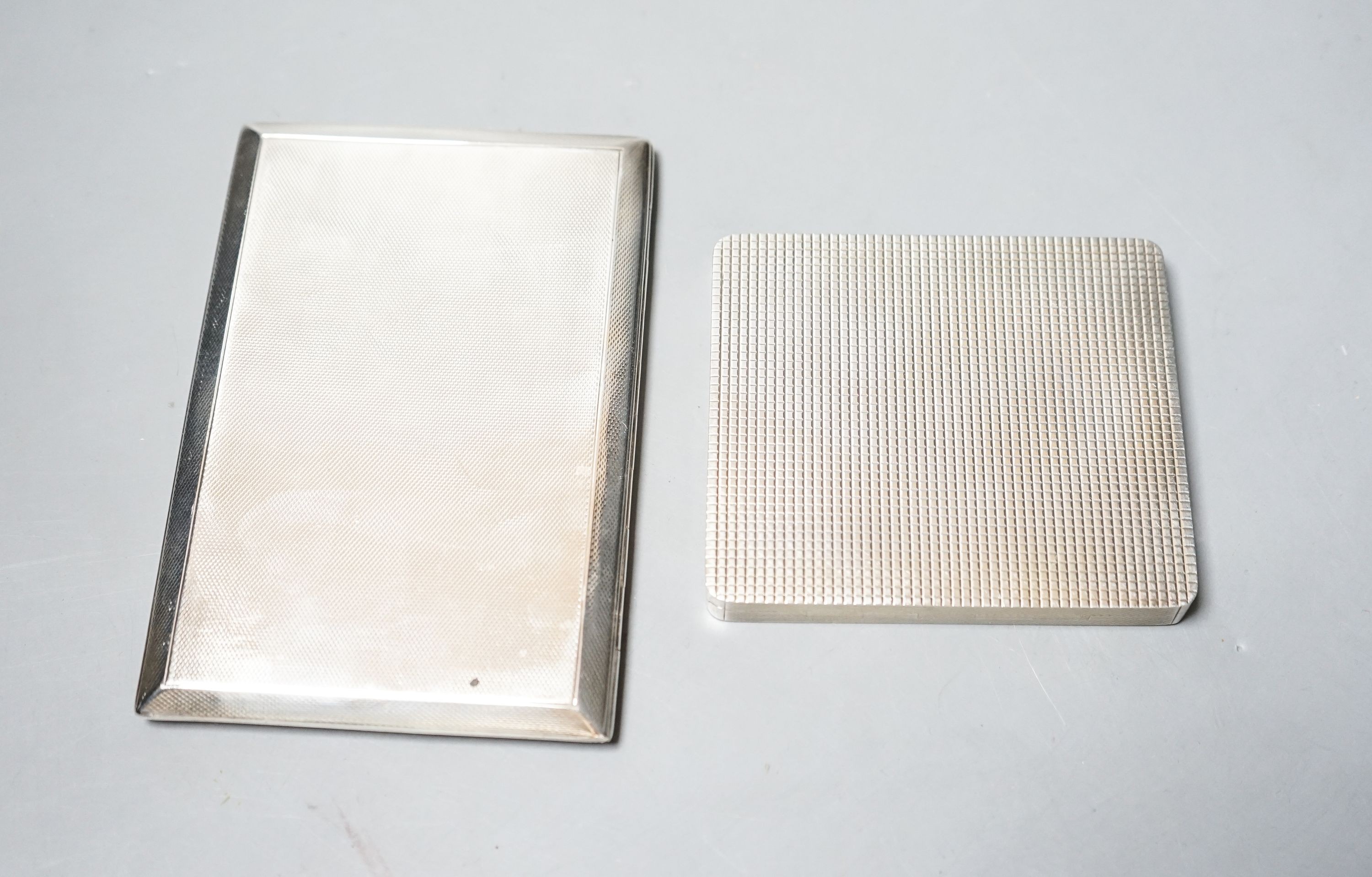 A George VI silver and yellow metal banded square cigarette case, London, 1950, 92mm and one other cigarette case, gross 3.4 grams.